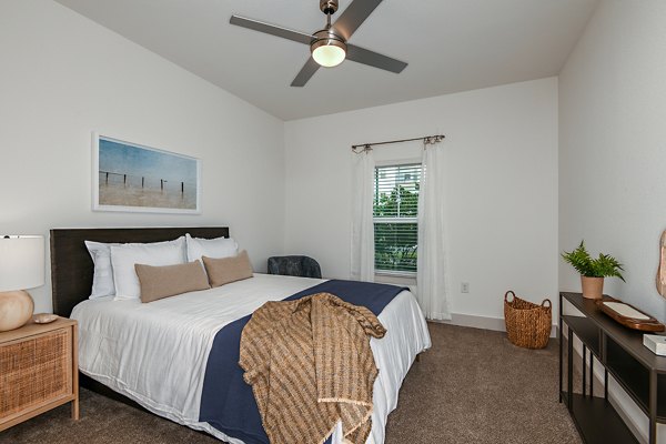 Bedroom with modern furnishings at Grand Cypress Apartments featuring luxury design