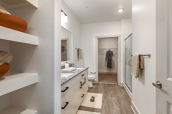 Modern bathroom featuring sleek fixtures and spacious layout in Grand Cypress Apartments, a luxury residence in a prime location