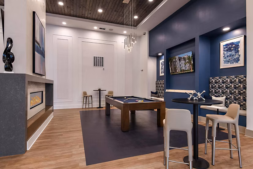 Clubhouse with modern decor and seating areas at Grand Cypress Apartments