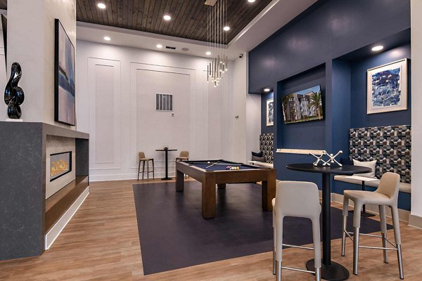 Clubhouse with modern decor and seating areas at Grand Cypress Apartments