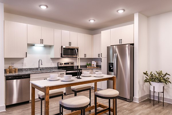 Modern kitchen featuring stainless steel appliances at Grand Cypress Apartments
