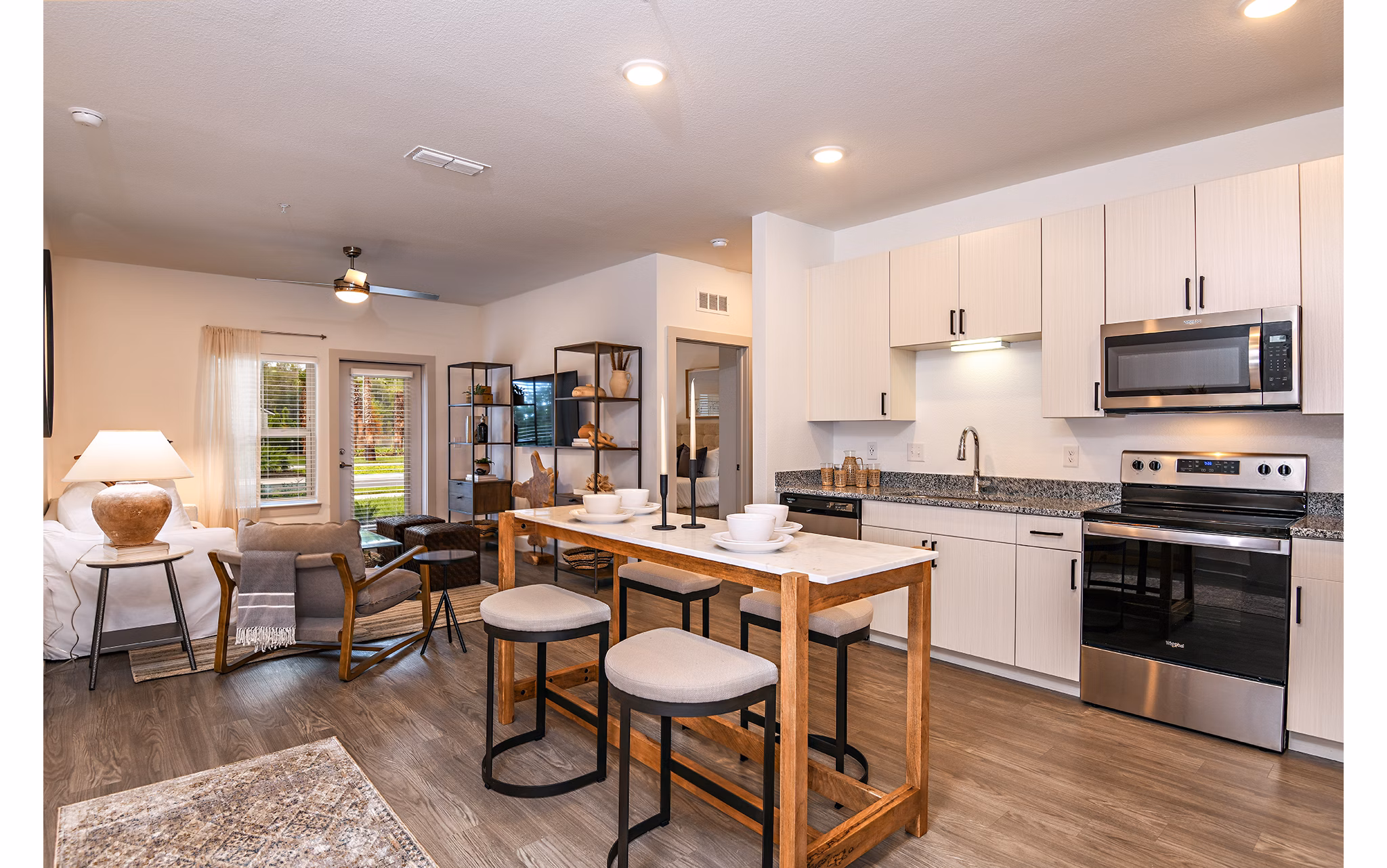 Modern kitchen with granite countertops and stainless steel appliances at Grand Cypress Apartments