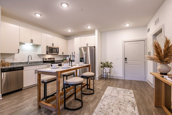 Modern kitchen with sleek appliances at Grand Cypress Apartments