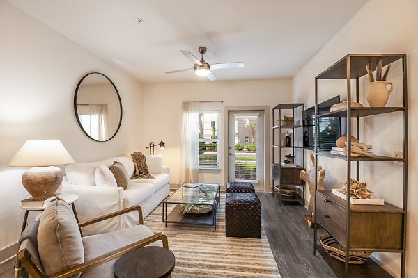 Modern living room with stylish furnishings in Grand Cypress Apartments, a luxury property managed by Greystar