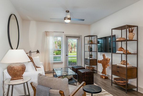 Spacious living room featuring modern furnishings at Grand Cypress Apartments in luxury Greystar community