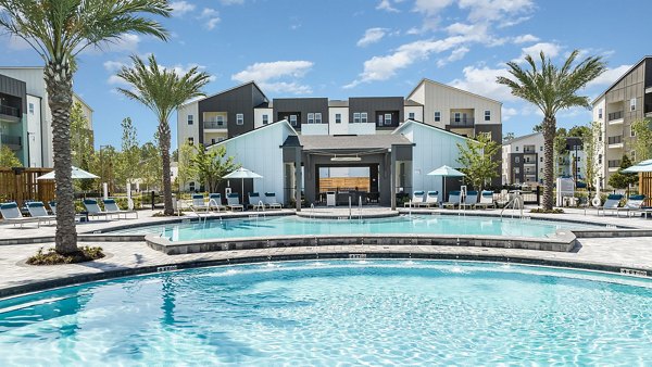 Resort-style pool with cabanas at Grand Cypress Apartments, offering luxury amenities for relaxation and leisure