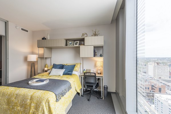 Luxurious bedroom with city views and modern decor at Evo at Cira Centre South Apartments, perfect for urban living in Greystar's premium locations