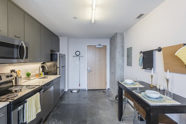 Modern kitchen with stainless steel appliances in Evo at Cira Centre South Apartments