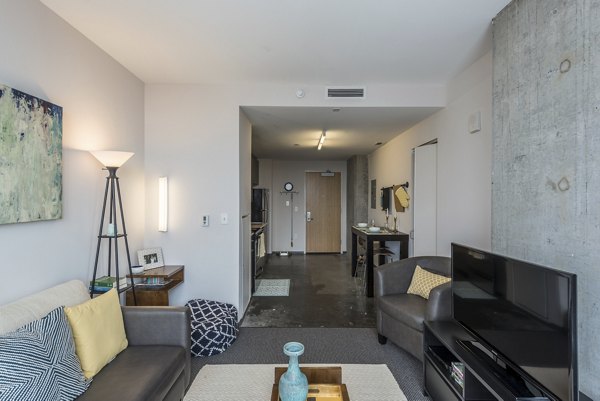 Spacious living room with modern decor at Evo at Cira Centre South Apartments
