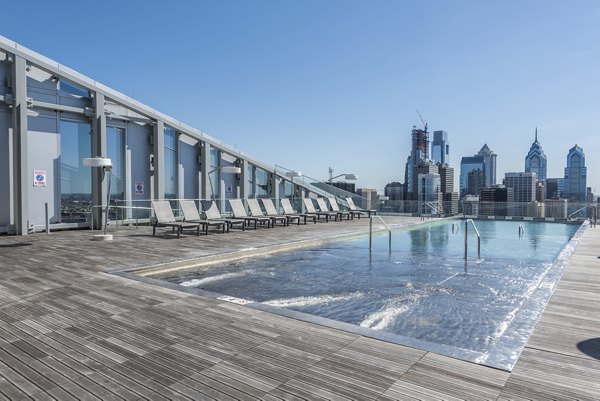Resort-style swimming pool with lounge seating at Bay Court at Harbour Pointe Apartments