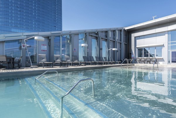 Resort-style pool with lounge chairs at Bay Court at Harbour Pointe Apartments
