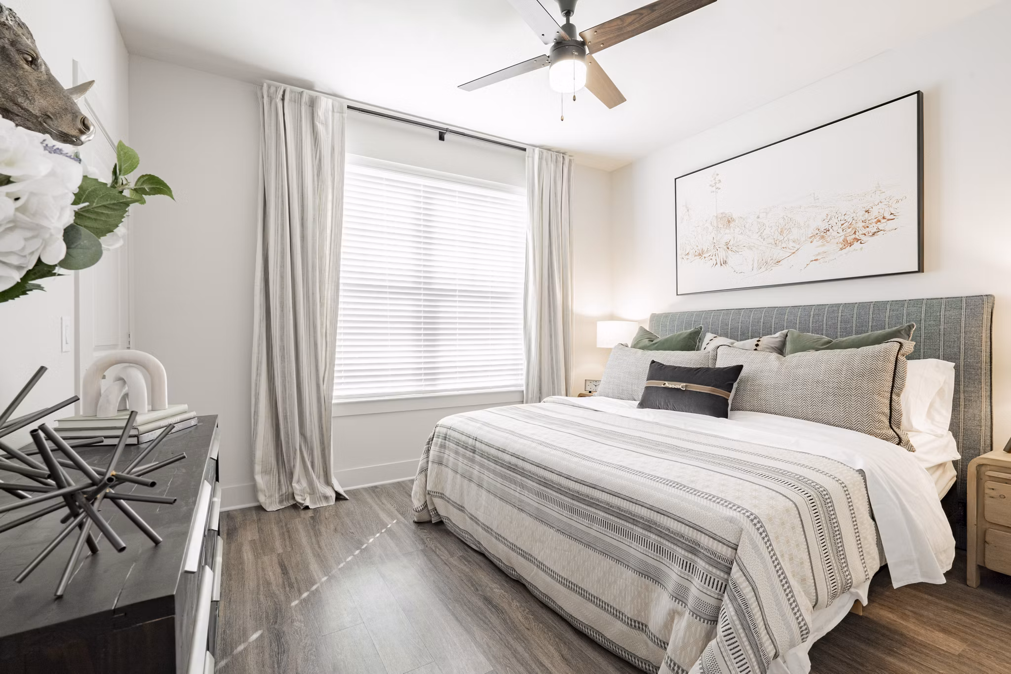 Cozy bedroom with modern furnishings at The Lyric at Keller Center Stage Apartments