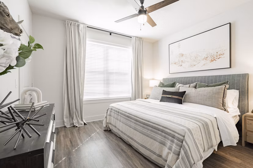 Cozy bedroom with modern furnishings at The Lyric at Keller Center Stage Apartments
