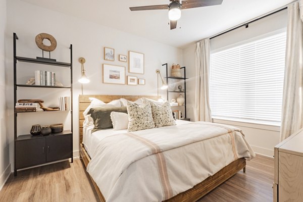 Bedroom featuring modern furnishings and sleek design in The Lyric at Keller Center Stage Apartments