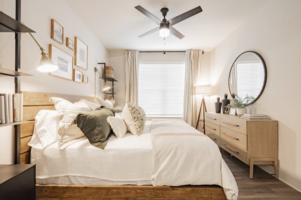 Cozy bedroom with modern furnishings at The Lyric at Keller Center Stage Apartments