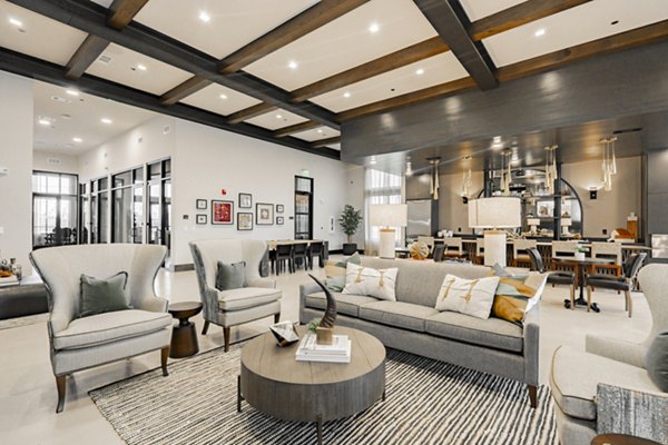 Modern clubhouse with elegant seating and large screen at The Lyric at Keller Center Stage Apartments