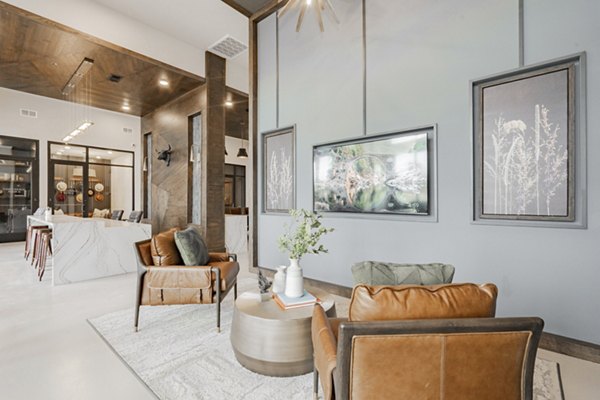 Luxurious clubhouse at The Lyric at Keller Center Stage Apartments featuring plush seating and modern decor