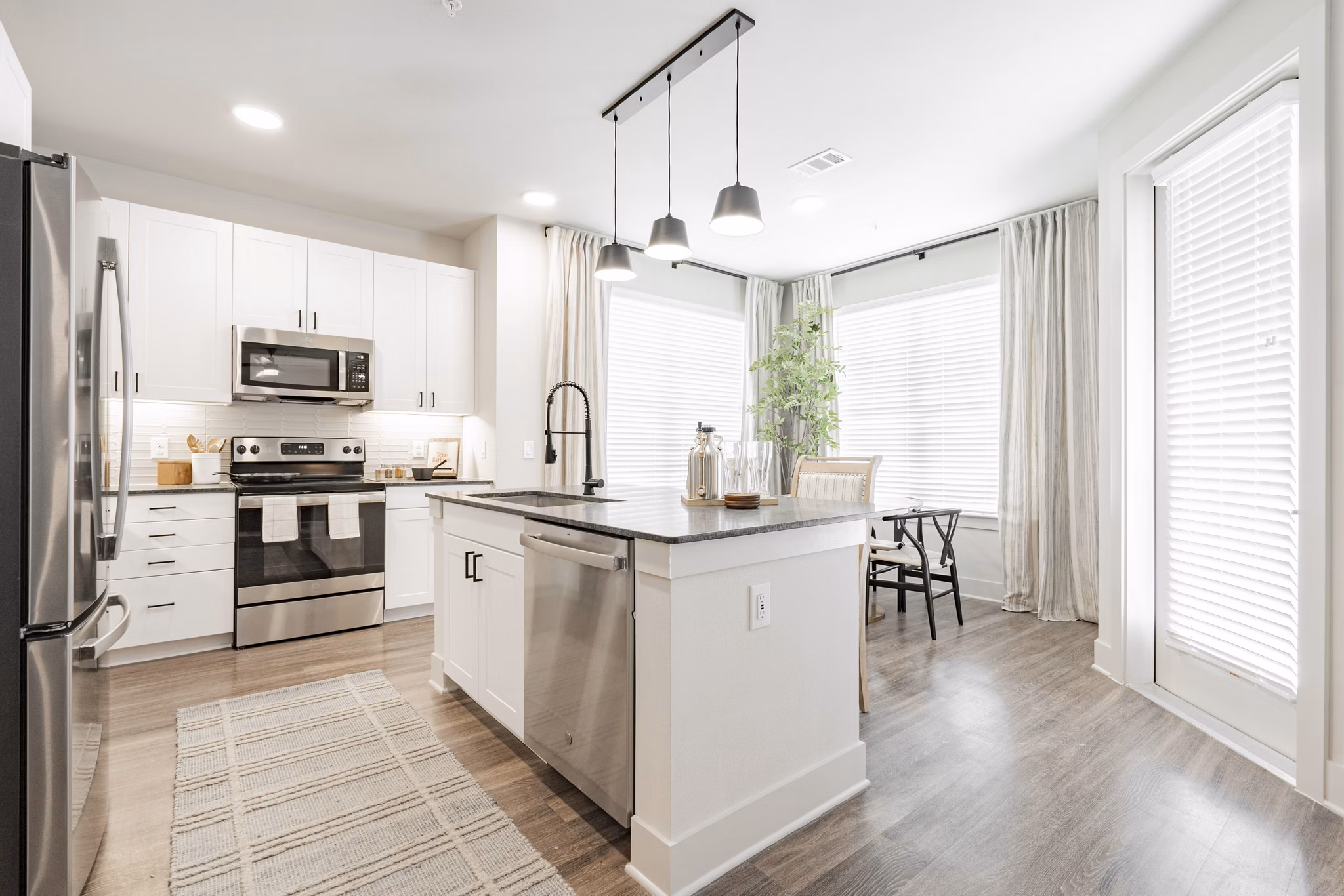 Modern kitchen with sleek countertops and stainless steel appliances in Lenox Reserve Apartments