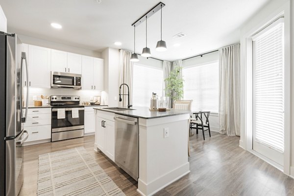 Modern kitchen with sleek countertops and stainless steel appliances in Lenox Reserve Apartments