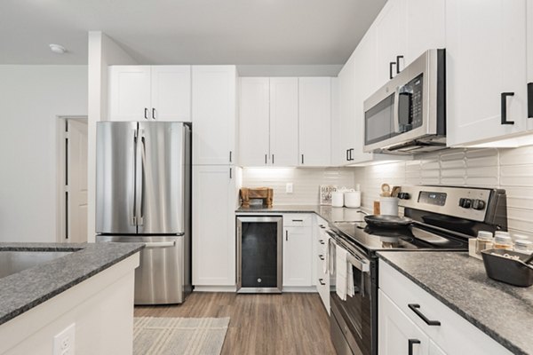 Spacious kitchen with modern appliances and granite countertops at Lenox Reserve Apartments