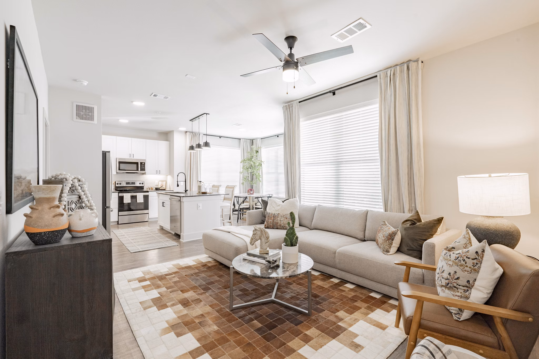 Spacious living room with contemporary furnishings in The Lyric at Keller Center Stage Townhomes, luxury apartments by Greystar