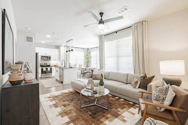 Spacious living room with contemporary furnishings in The Lyric at Keller Center Stage Townhomes, luxury apartments by Greystar