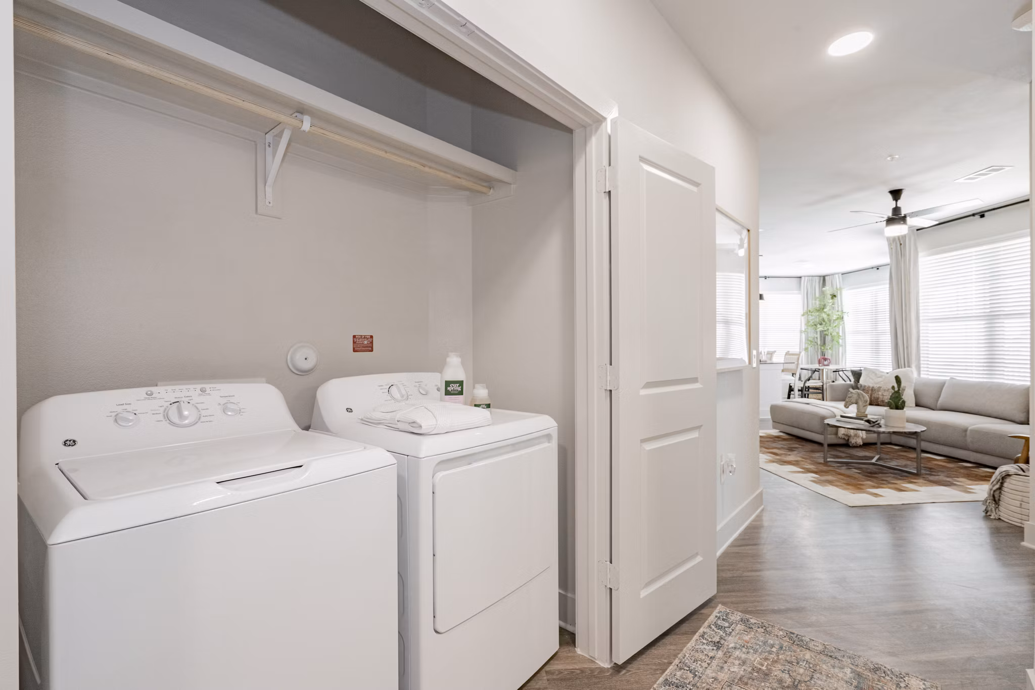 Laundry room with modern appliances and ample storage at The Lyric at Keller Center Stage Apartments