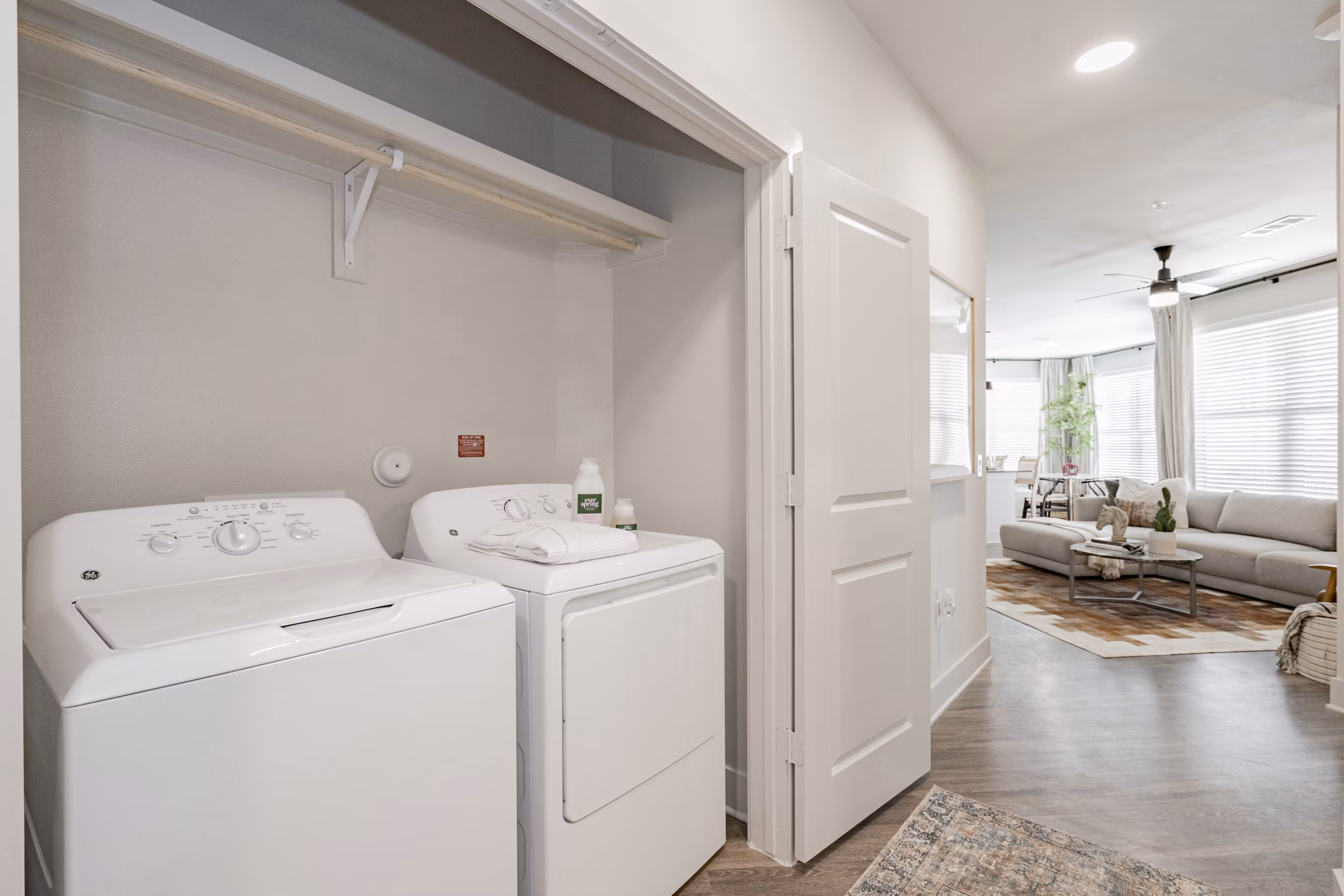 Laundry room with modern appliances and ample storage at The Lyric at Keller Center Stage Apartments
