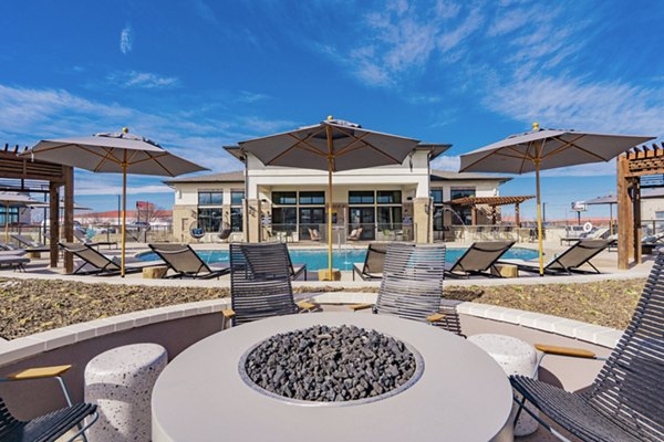 Cozy outdoor fire pit with seating at The Lyric at Keller Center Stage Apartments