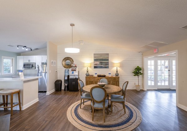 Clubhouse at North Hill Apartments featuring a modern lounge area with vaulted ceilings and stylish decor