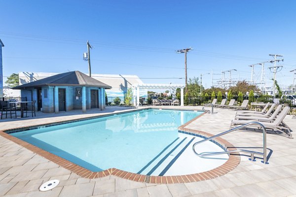 Relax by the serene pool at North Hill Apartments, a luxurious living community offering premium amenities