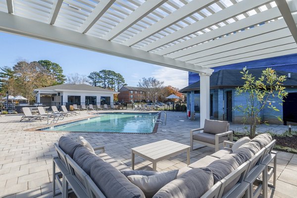 Resort-style pool with sun loungers at North Hill Apartments, offering luxury amenities in a tranquil setting