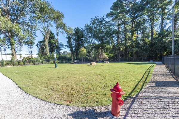 Leash-free dog park with agility equipment at North Hill Apartments