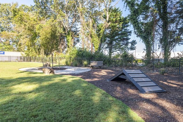 Spacious dog park at North Hill Apartments with agility equipment