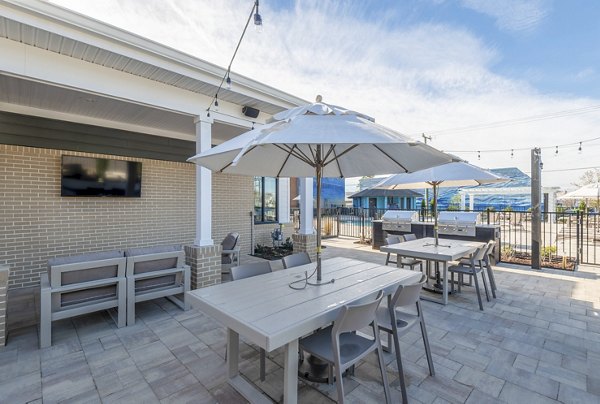 Outdoor grill area with stainless steel appliances at North Hill Apartments