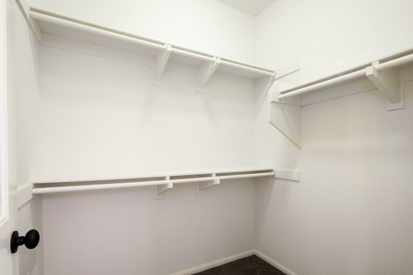Cozy bedroom featuring modern decor and ample natural light at Jackson Pointe 111 Apartments