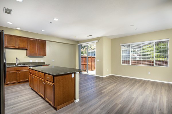Spacious kitchen featuring modern appliances and granite countertops in Jackson Pointe 111 Apartments