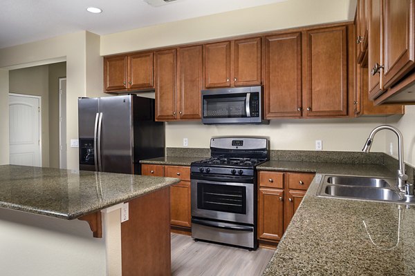 Modern kitchen with stainless steel appliances at Jackson Pointe 111 Apartments