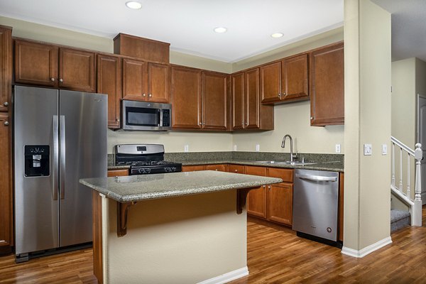 Modern kitchen with stainless steel appliances at Jackson Pointe 111 Apartments, luxury living by Greystar