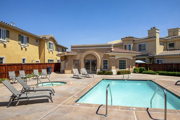 Refreshing poolside relaxation area at Jackson Pointe 111 Apartments offering a serene outdoor escape with lounge chairs and lush landscaping