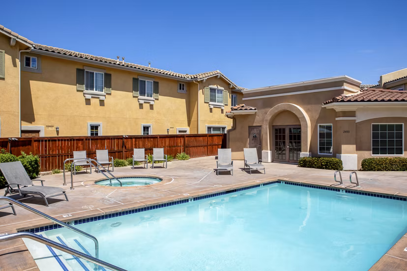 Sparkling pool at Jackson Pointe 111 Apartments with surrounding lounge chairs, ideal for relaxation and leisure