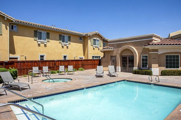 Sparkling pool at Jackson Pointe 111 Apartments with surrounding lounge chairs, ideal for relaxation and leisure