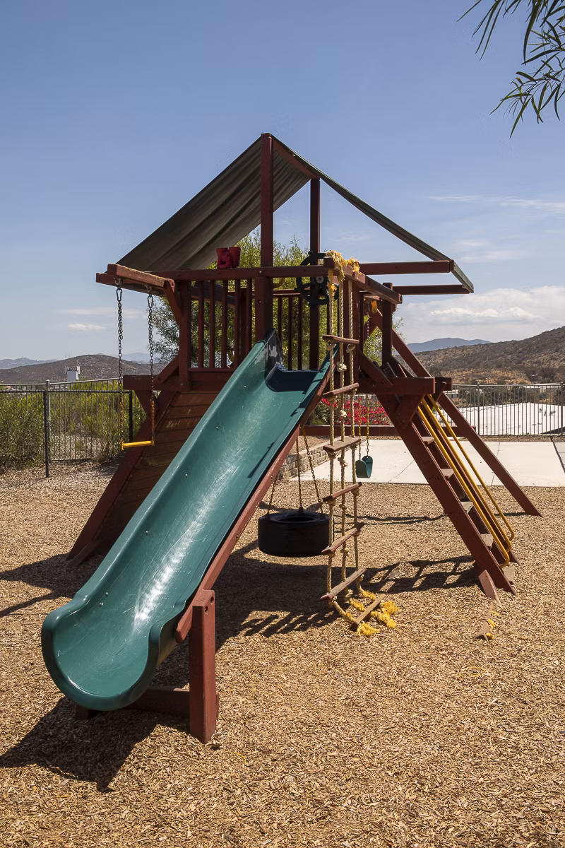 Kids playing on modern playground at Jackson Pointe 111 Apartments, a family-friendly space promoting outdoor activities and fun