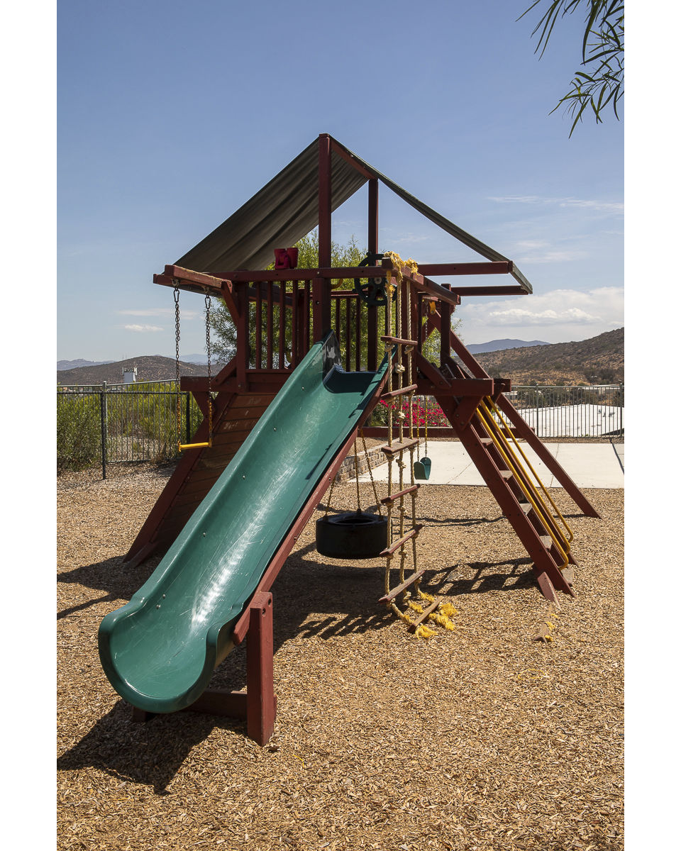 Kids playing on modern playground at Jackson Pointe 111 Apartments, a family-friendly space promoting outdoor activities and fun