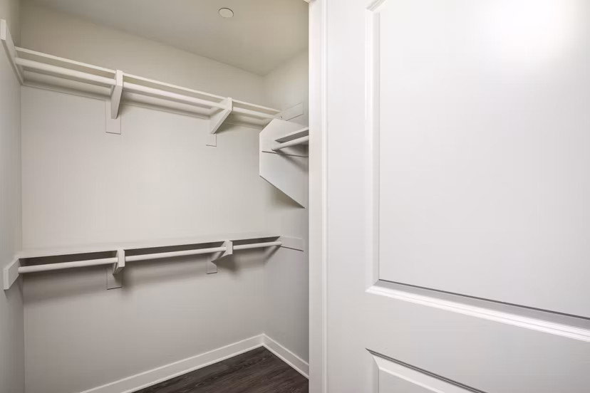 Walk-in closet with custom shelving at Lakeview 88 Apartments, luxury living space designed for organization and style