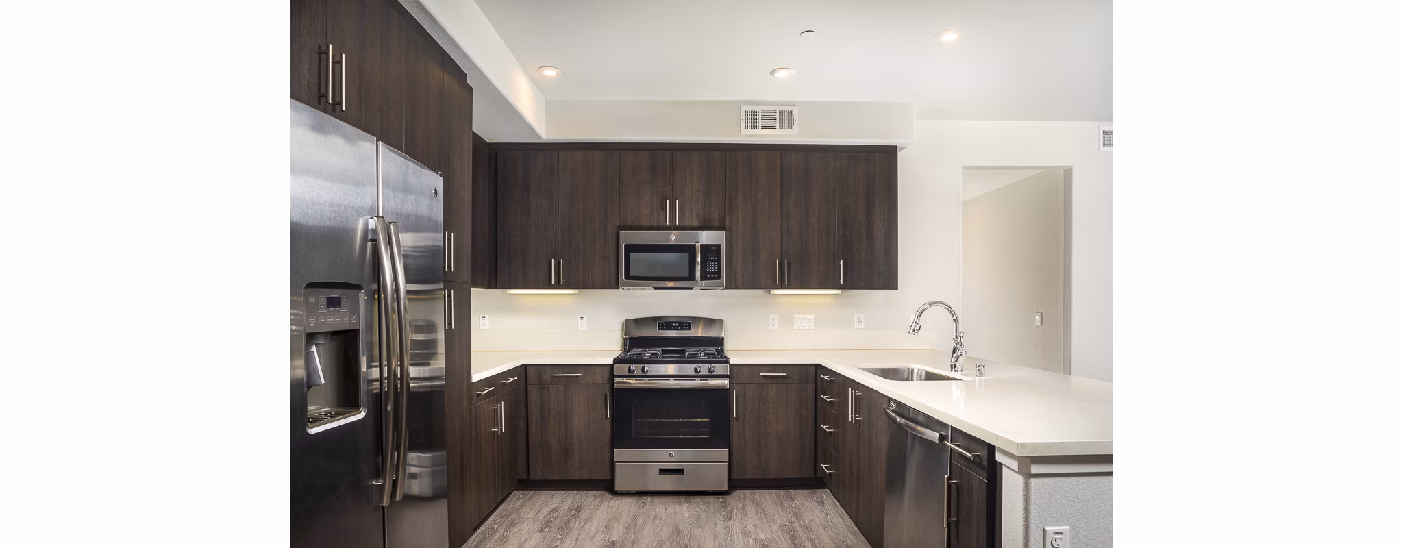 Modern kitchen with stainless steel appliances in Lakeview 88 Apartments