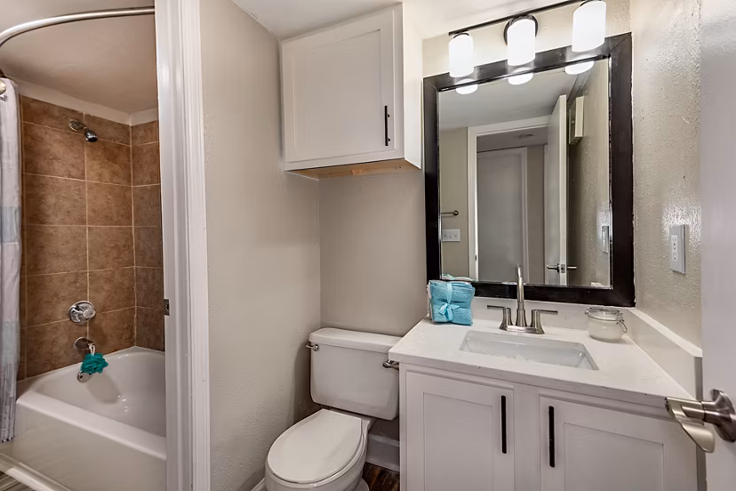 Bathroom with sleek fixtures and granite countertops in Lake Pointe Apartments
