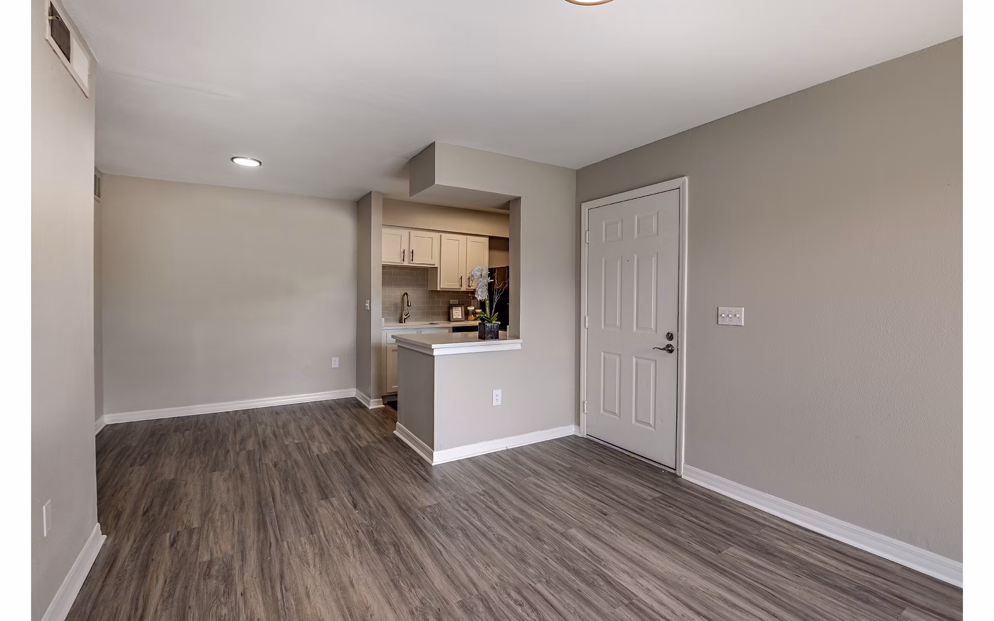 Living room featuring modern decor and large windows at Lake Pointe Apartments