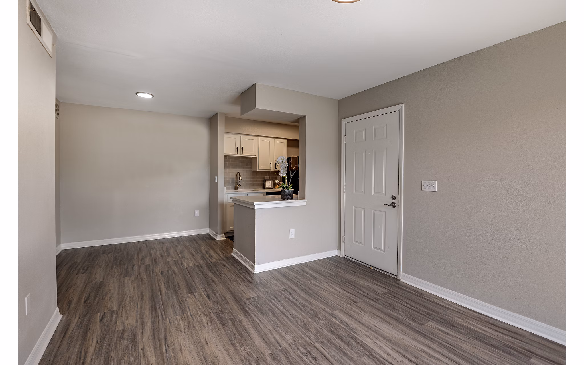 Living room featuring modern decor and large windows at Lake Pointe Apartments