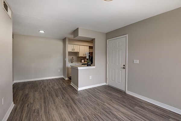 Living room featuring modern decor and large windows at Lake Pointe Apartments